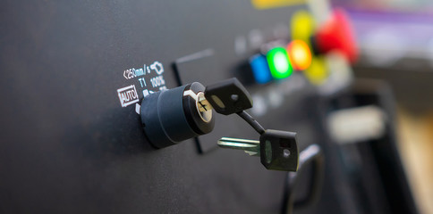 Close up of key switch on robot conroller panel of automation machine