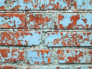 Old texture cracked red brick wall, the old blue paint texture is chipping and cracked fall destruction. Grunge wall texture for design. Cracked color background.