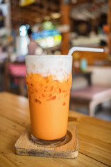 Thai Iced tea with cream on the table in outdoor cafe