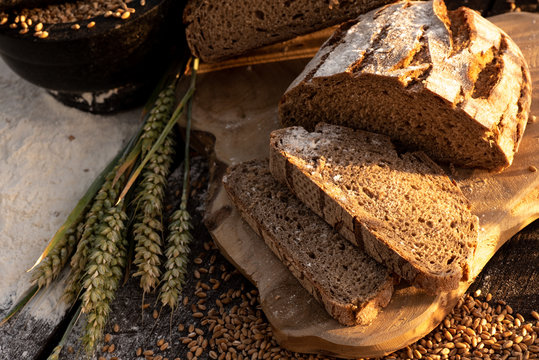 bread flour and corn on a old table with cornfield in the background
