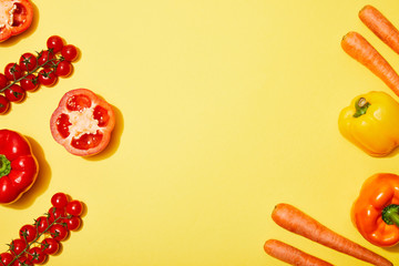 top view of red and orange vegetables on yellow background