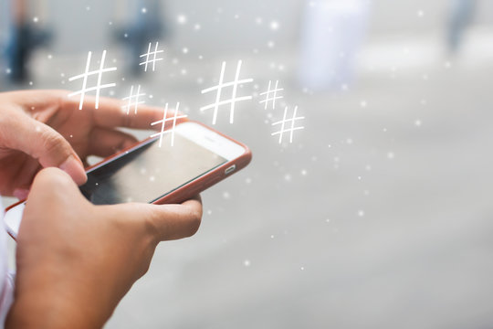 woman's hand is playing Social Media idea a word or phrase preceded by a hash or pound sign (#) and used to identify messages on a specific topic.