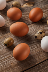 quail and chicken eggs on wooden table