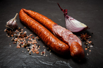appetizing smoked dry sausage with garlic and slice of onion