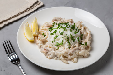 Squid in sour cream sauce. Greek national dish