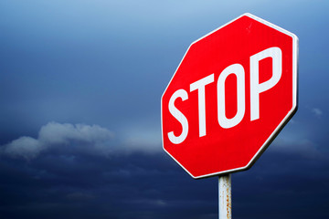 Conceptual stop sign with stormy background. Warning, caution and danger sign