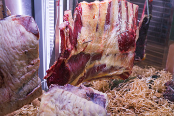 Display of Dry Aged Meat Steaks in butchers shop or restaurant in an display refrigerator.