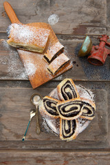 Poppy seed strudel. Homemade cake. Rustic wooden backgroud. Top view. Picnic in nature.