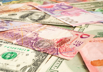 Cash money from various countries (Dollar, Qatari riyal, hryvnia). Exchange business concept background
