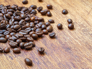 Extreme closeup of roasted coffee beans on wooden background