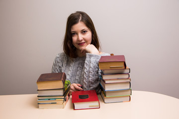 Student girl with stack of books 