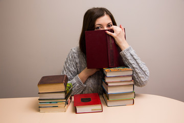 Student girl with stack of books 