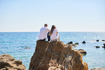 couple in love travels around islands and mountains. Couple in love hugging on a tropical beach with a turquoise water