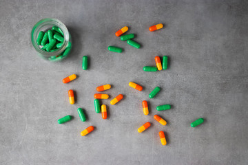 Bright pills on a gray background.