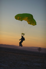Landing skydiver under the reserve parachute after the malfunction of the main canopy. Parachute jumps. Parachute equipment.