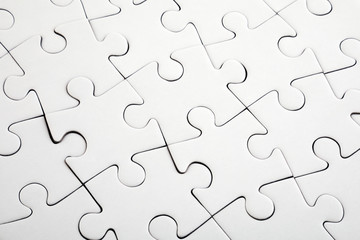 Fototapeta premium Top view of white jigsaw puzzle