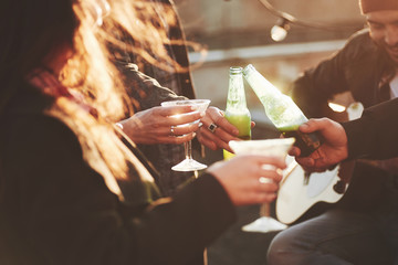 Let's drink for good mood. It's rooftop party. Group of friends have holidays at sunny autumn day