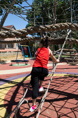 the kid play in the park with climbing stand.