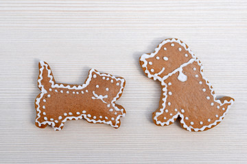 Cute gingerbread cat and dog on wooden background