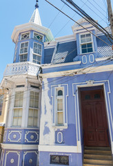 Manor house on a hill in Valparaiso, with the paint worn by the wind and salt, and the typical electric cables.