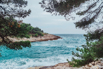 landscape view of stormy sea water with rocky beach