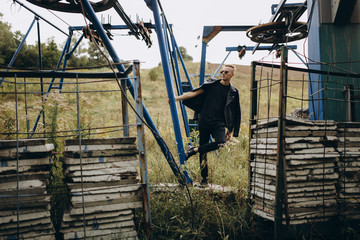 Young sexy man dress in black style leather jacket and sunglasses standing outdoor