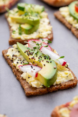 Sandwiches with cream cheese, vegetables and salami.