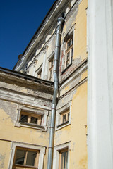 Fototapeta na wymiar Windows and drainpipes of the old house