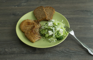 Baked pork, cabbage salad, cucumbers, brine cheese and grain bread