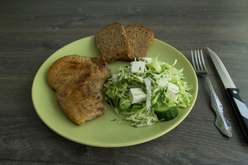 Baked pork, cabbage salad, cucumbers, brine cheese and grain bread