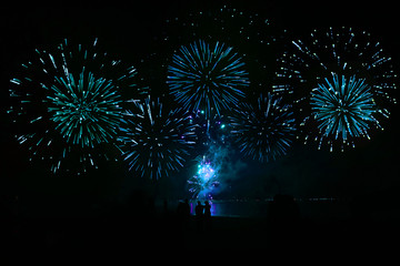 Fireworks light up the night sky over Blue tone Nai Yang Beach, Phuket, Thailand