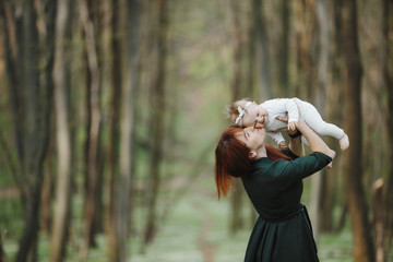 Happy mom kisses her baby