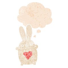 cute cartoon rabbit with love heart and thought bubble in retro textured style