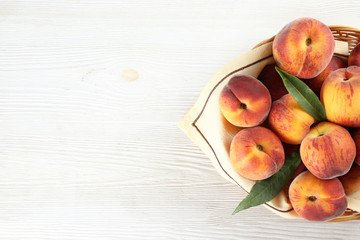 Bunch of ripe organic peaches in pile on wood textured table. Local produce harvest heap. Clean eating concept. Background, top view, close up, copy space, flat lay.