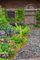 Landscaped backyard of a old house with flowering garden