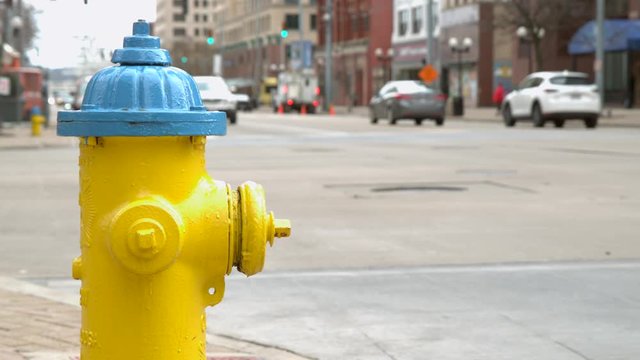 City fire hydrant with cars in background slow motion