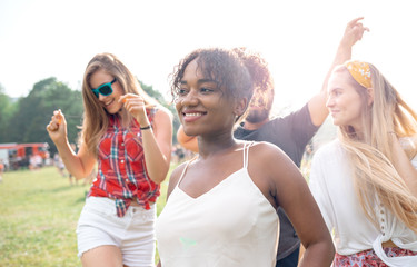 Multiethnic group of young people having fun at music festival