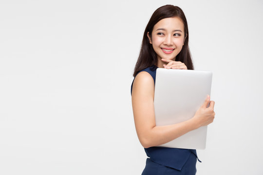 Happy Asian Business Woman Holding Laptop Computer And Looking Away On White Background