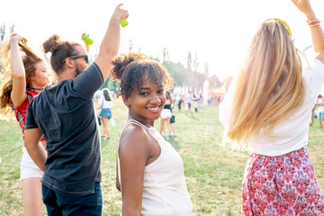 Multiethnic group of people having fun at summer music festival