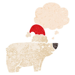 cartoon bear wearing christmas hat and thought bubble in retro textured style