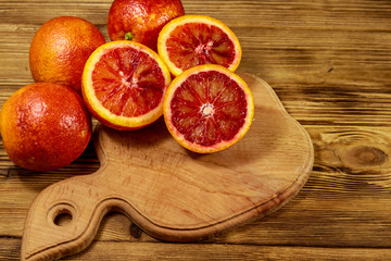 Red blood oranges on wooden table
