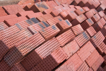  New red clay bricks for masonry building walls. Material for the construction of a new building.