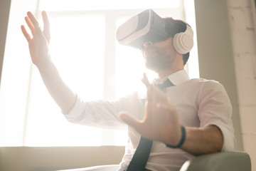 Businessman testing new app in VR goggles