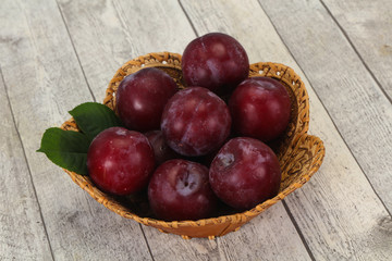 Plum heap in the wooden basket
