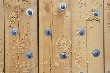 Background of wooden beams fixed between each other by large bolts