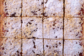 Pieces of homemade cookies apricot jam powdered sugar texture close up