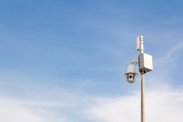 Security Camera on a blue sky background. Surveillance camera for guarding territory. Security of private property.