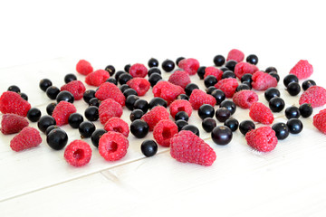 raspberry and black currant on wooden table
