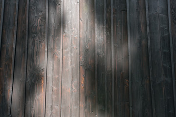 Natural dark stained wood building wall background.