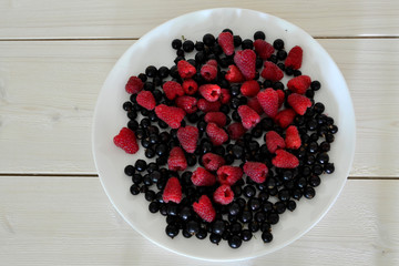 Frozen berries on a white wooden table